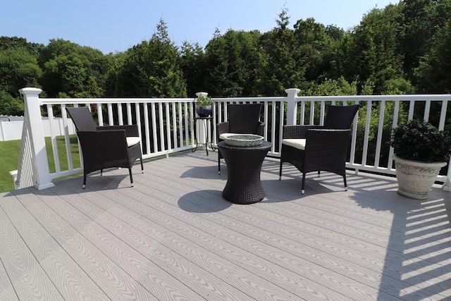 wooden deck with a forest view