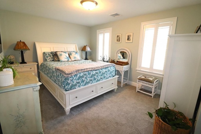 bedroom with visible vents and carpet flooring