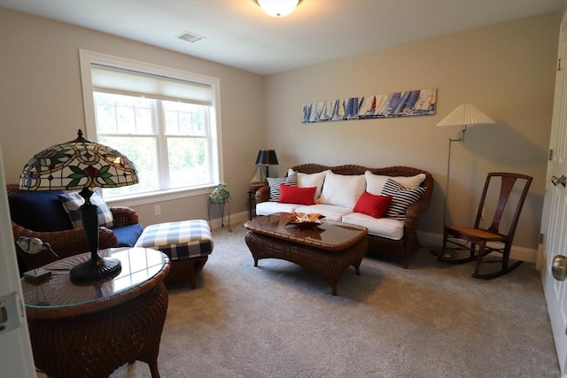 living room featuring visible vents, carpet flooring, and baseboards