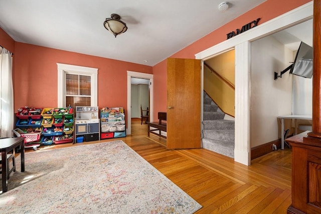 playroom featuring baseboards and parquet flooring