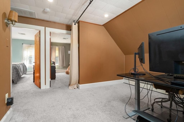 office space featuring carpet floors, baseboards, visible vents, and lofted ceiling