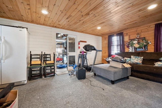 living area with recessed lighting, wooden ceiling, wood walls, and carpet