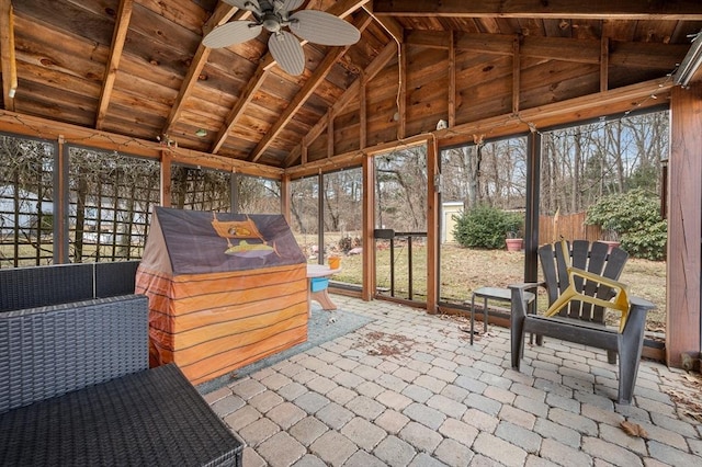 sunroom featuring a ceiling fan, wood ceiling, and vaulted ceiling with beams