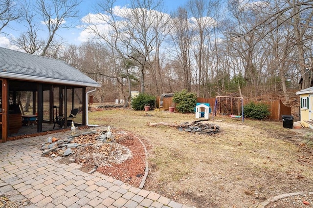 view of yard with an outdoor fire pit, fence, and an outdoor structure