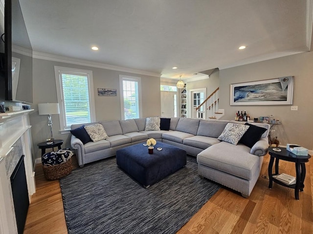38 John Perkins Way, Middleboro, MA 02346 - living room featuring light wood-style floors, a fireplace, stairs, ornamental molding, and recessed lighting