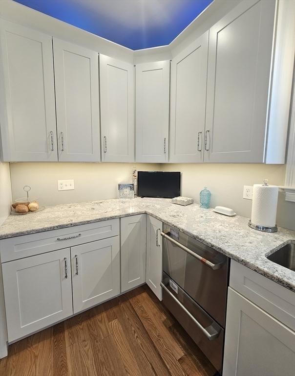 38 John Perkins Way, Middleboro, MA 02346 - kitchen featuring dark wood finished floors, light stone counters, white cabinets, and dishwasher