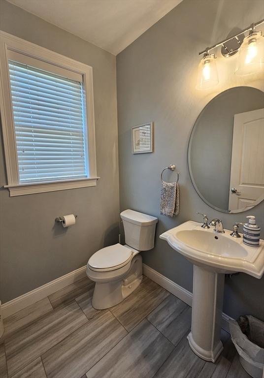 38 John Perkins Way, Middleboro, MA 02346 - bathroom with toilet, wood finished floors, baseboards, and a sink