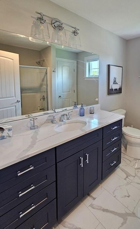 38 John Perkins Way, Middleboro, MA 02346 - full bath featuring marble finish flooring, a stall shower, vanity, and toilet
