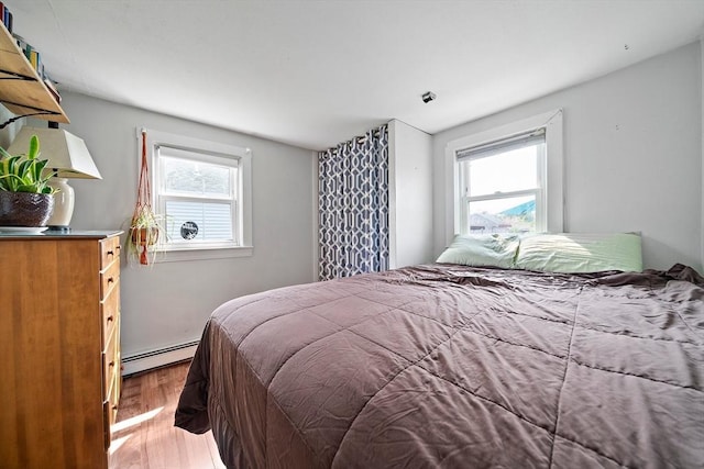 22 Mcarthur Ln, Marshfield, MA 02050 - bedroom featuring baseboard heating and wood finished floors