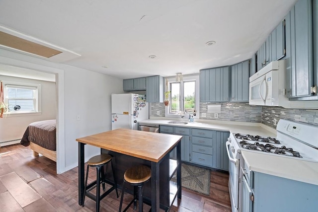 22 Mcarthur Ln, Marshfield, MA 02050 - kitchen featuring white appliances, blue cabinets, a sink, and tasteful backsplash
