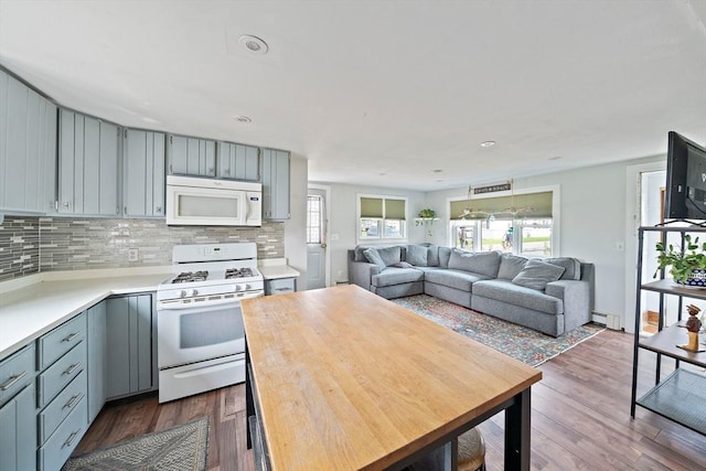22 Mcarthur Ln, Marshfield, MA 02050 - kitchen featuring white appliances, backsplash, light countertops, dark wood-style floors, and a baseboard radiator