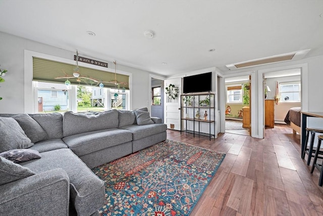22 Mcarthur Ln, Marshfield, MA 02050 - living room featuring wood finished floors, healthy amount of natural light, attic access, and a baseboard heating unit