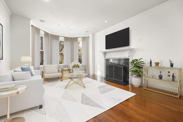 living room featuring hardwood / wood-style floors and crown molding