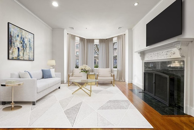 living room featuring ornamental molding and hardwood / wood-style flooring