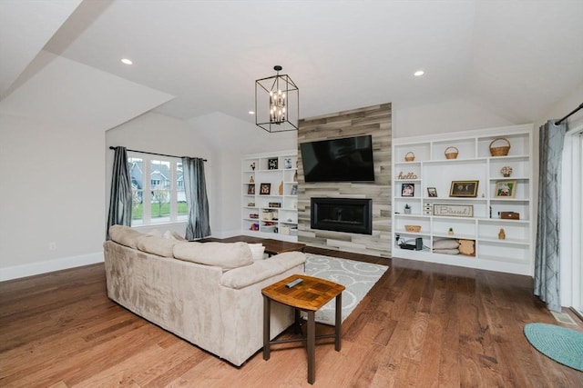 living room featuring lofted ceiling, baseboards, and wood finished floors