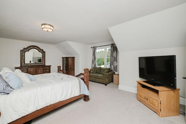 bedroom with light carpet, lofted ceiling, and baseboards
