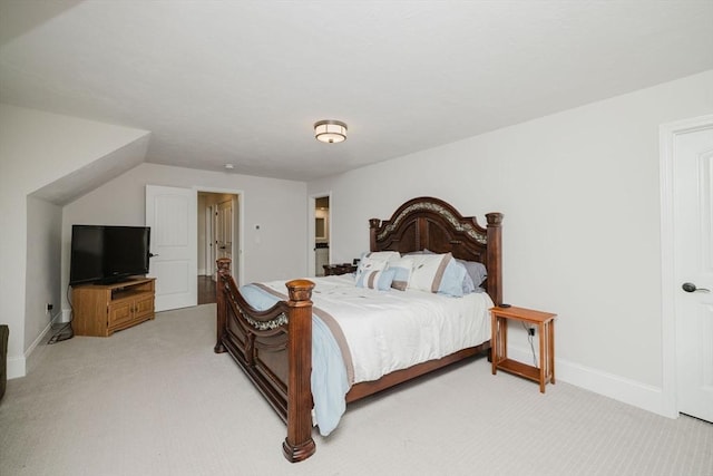 bedroom with light carpet and baseboards