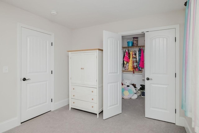 bedroom featuring baseboards and light carpet