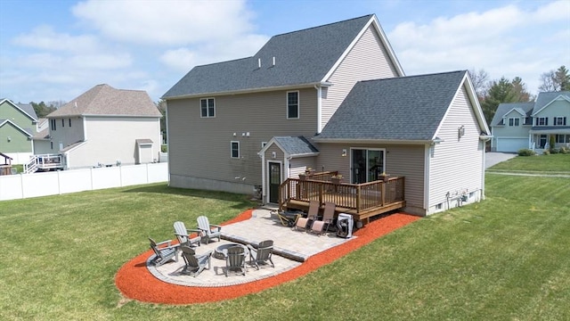 rear view of property with a lawn, a patio, an outdoor fire pit, and a deck