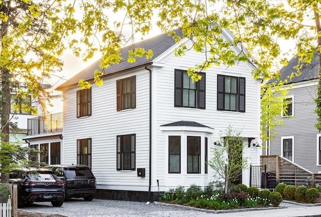colonial home with roof with shingles