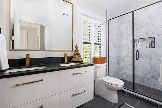 full bathroom featuring a shower stall, tile patterned flooring, vanity, toilet, and vaulted ceiling
