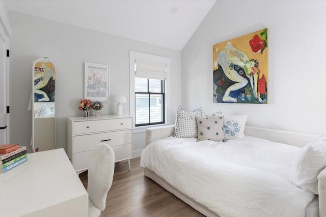 bedroom featuring vaulted ceiling and wood finished floors