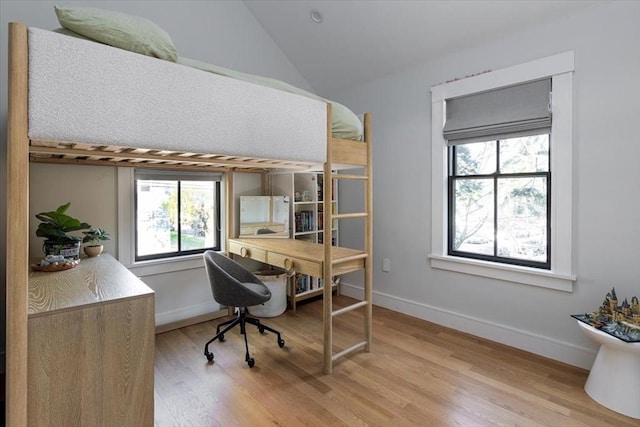 office featuring light wood-type flooring, lofted ceiling, and baseboards