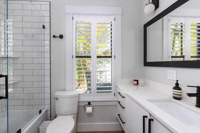 full bathroom with toilet, plenty of natural light, shower / washtub combination, and vanity