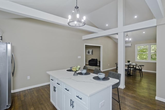 24 Old Jarvis Ave, Holyoke, MA 01040 - kitchen with freestanding refrigerator, a chandelier, dark wood-type flooring, a wall unit AC, and white cabinets