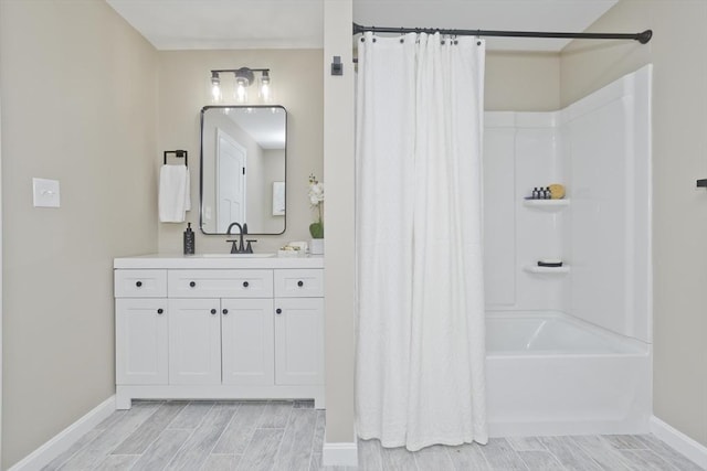 24 Old Jarvis Ave, Holyoke, MA 01040 - full bathroom with baseboards, vanity, wood finish floors, and shower / tub combo