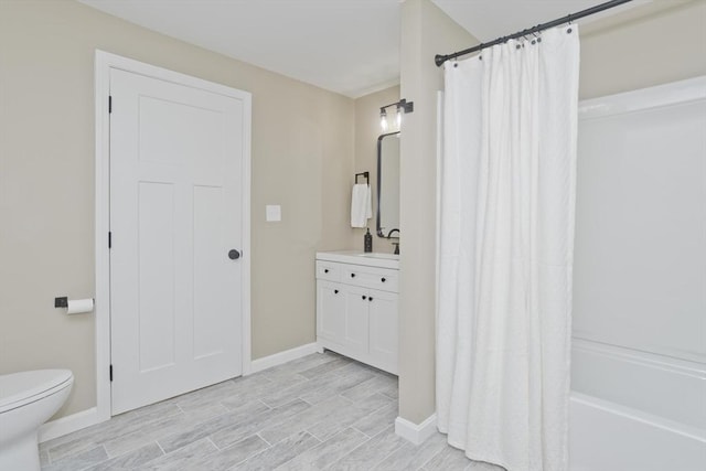 24 Old Jarvis Ave, Holyoke, MA 01040 - full bath featuring vanity, toilet, baseboards, wood finished floors, and shower / bath combination with curtain