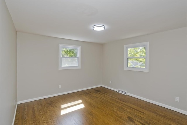 24 Old Jarvis Ave, Holyoke, MA 01040 - spare room featuring plenty of natural light, dark wood finished floors, and baseboards