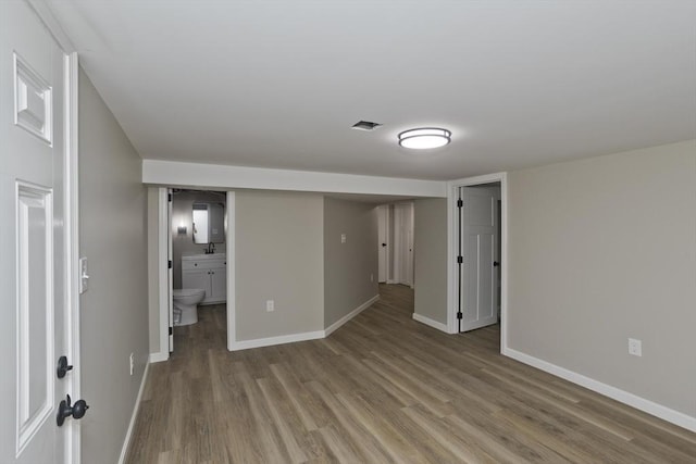 24 Old Jarvis Ave, Holyoke, MA 01040 - unfurnished bedroom featuring wood finished floors, baseboards, and ensuite bathroom