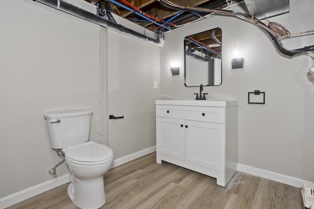 24 Old Jarvis Ave, Holyoke, MA 01040 - bathroom with vanity, wood finished floors, toilet, and baseboards