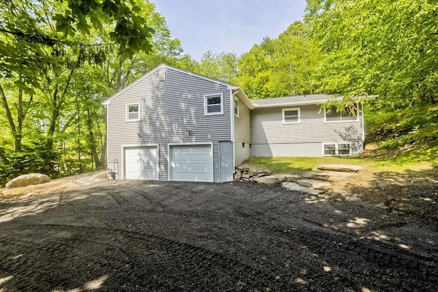 24 Old Jarvis Ave, Holyoke, MA 01040 - view of side of home with a garage and asphalt driveway