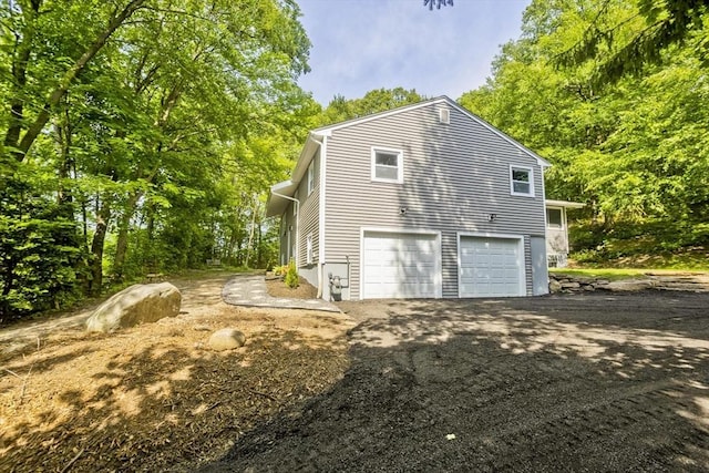 24 Old Jarvis Ave, Holyoke, MA 01040 - view of home's exterior featuring an attached garage and asphalt driveway