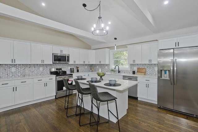 24 Old Jarvis Ave, Holyoke, MA 01040 - kitchen featuring appliances with stainless steel finishes, a breakfast bar, white cabinets, and recessed lighting