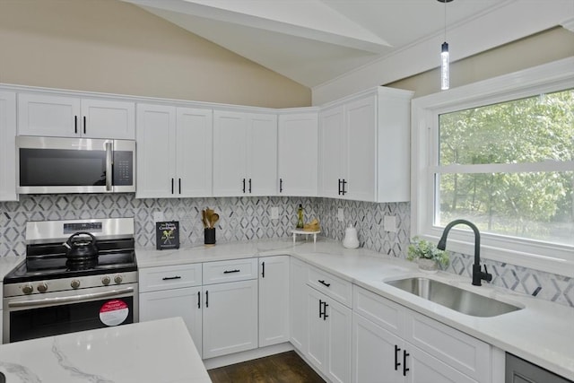 24 Old Jarvis Ave, Holyoke, MA 01040 - kitchen featuring stainless steel appliances, a sink, vaulted ceiling, white cabinets, and decorative backsplash
