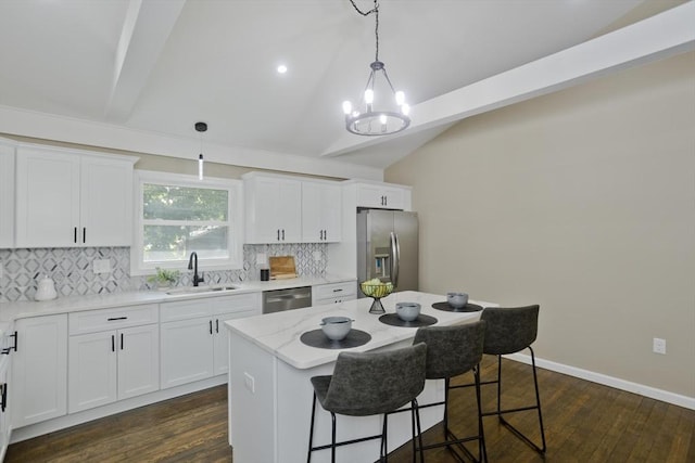 24 Old Jarvis Ave, Holyoke, MA 01040 - kitchen with stainless steel appliances, a sink, a chandelier, decorative backsplash, and a breakfast bar area