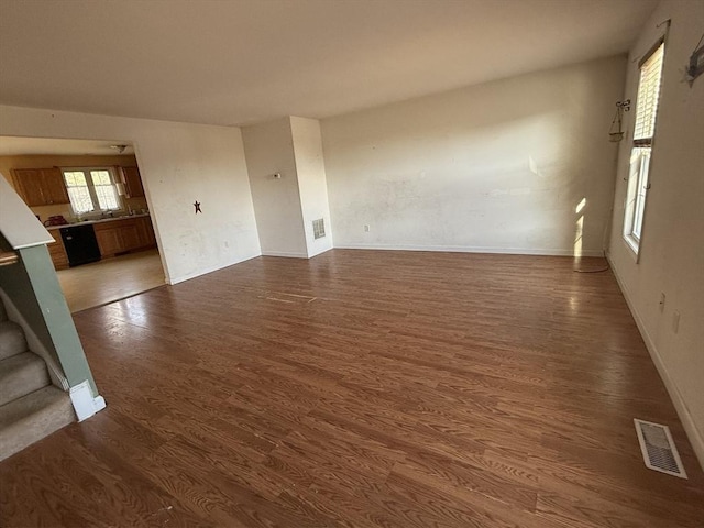 unfurnished living room featuring dark hardwood / wood-style flooring