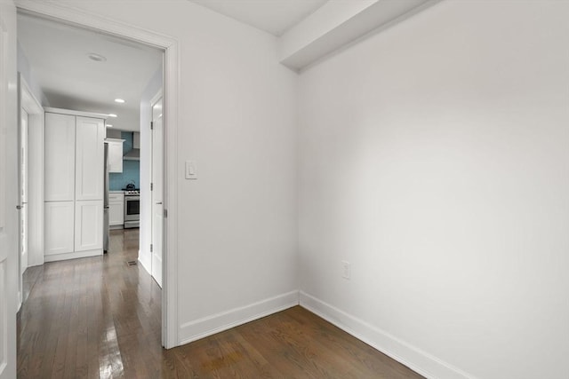 hallway with baseboards, recessed lighting, and dark wood finished floors