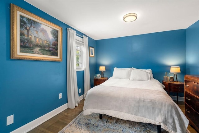 bedroom featuring baseboards and wood finished floors