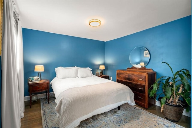 bedroom featuring baseboards and wood finished floors