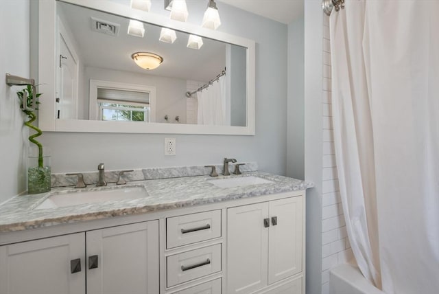 bathroom with double vanity, visible vents, a sink, and shower / tub combo with curtain