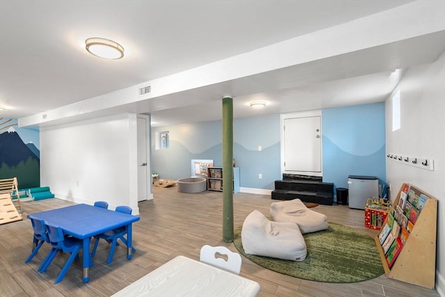 playroom featuring baseboards, visible vents, and light wood-type flooring