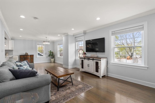 living room featuring an inviting chandelier, baseboards, ornamental molding, and recessed lighting