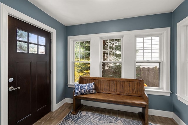 entryway featuring baseboards and wood finished floors