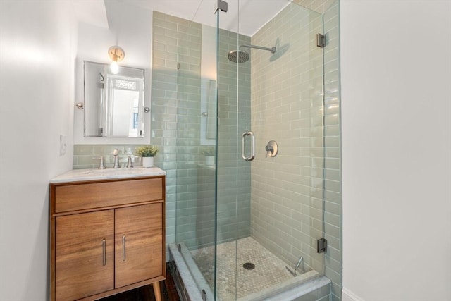 bathroom with a stall shower and vanity