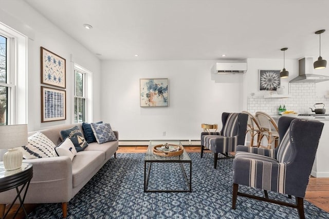 living room featuring recessed lighting, a baseboard heating unit, wood finished floors, baseboards, and a wall mounted air conditioner