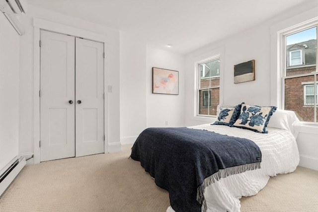 carpeted bedroom with baseboards, multiple windows, and baseboard heating